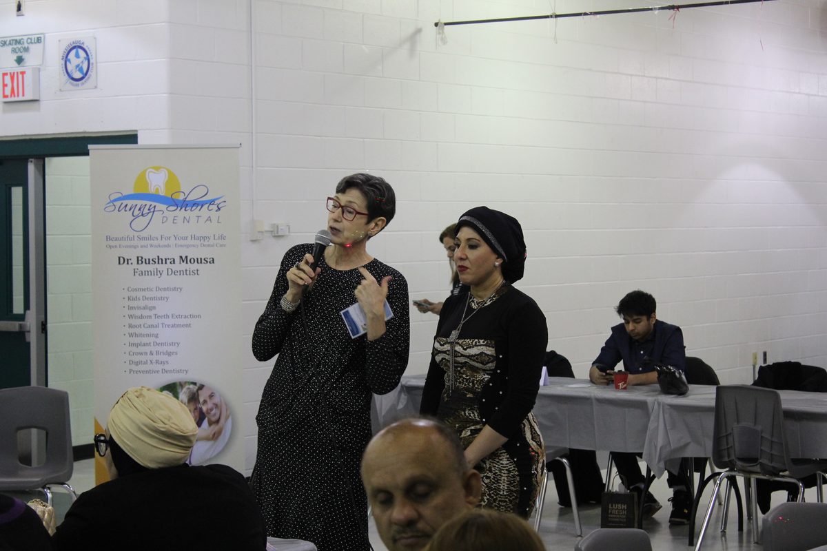 A Community Matters Mississauga volunteer speaking to neighbours at a community gathering